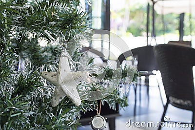 White star is decorated onâ€‹ pine tree.Merry christmasâ€‹ andâ€‹ happyâ€‹ newâ€‹ yearâ€‹ festivalâ€‹ concept.2023 happyâ€‹ day Stock Photo